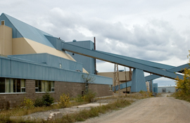 Galleries between the conveyor decline (hidden on right), oarse-ore storage building (on left), and crusher house (in middle), Mount Pleasant mine.